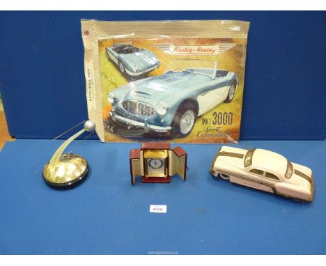 A miniature Brass eight day Carriage Clock with alarm by Looping, signed Dave Gaunt '74, a 1950's pink metal friction drive A
