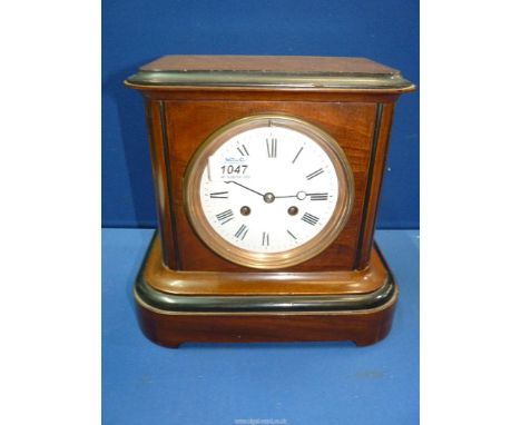 A 19th century Mahogany and ebonised eight day, two train movement Mantel Clock, strikes 1/2 hour on a bell, white enamel fac