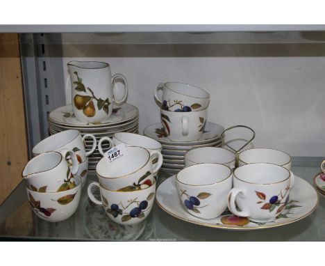 A part Royal Worcester "Evesham" teaset to include: twelve cups and tea plates, seven saucers, milk jug, sugar bowl and a cak