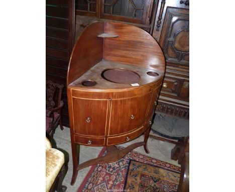 A Georgian Mahogany bow fronted Corner Washstand having boxwood beading, a central cupboard door and drawer below, three rece