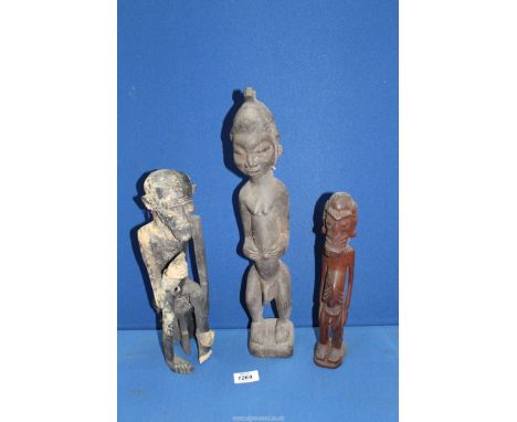 Three carved wood tribal type figures of men, one with distressed, hand-woven wrap/sash, 12 3/4" high x 17 1/4" high and 11 5