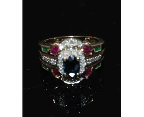 9CT DIAMOND SAPPHIRE RUBY AND EMERALD CLUSTER RING.