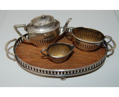 MINIATURE ANTIQUE & GILT 3 PIECE TEA SERVICE WITH FLUTED DECORATION TOGETHER WITH AN OVAL WOOD & SILVER 2 HANDLED TRAY. EACH 