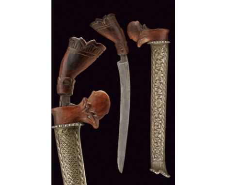 dating: circa 1900 provenance: Sulawesi, Curved, single-edged blade, in pamor; wooden grip embossed with floral motifs; woode