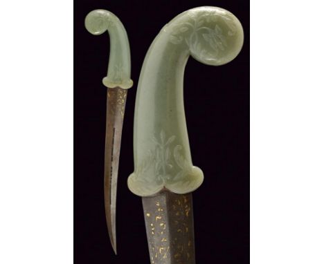 dating:  provenance: India, Curved, double-edged blade, in damask, two rectangular openings along the center, grooved inside 