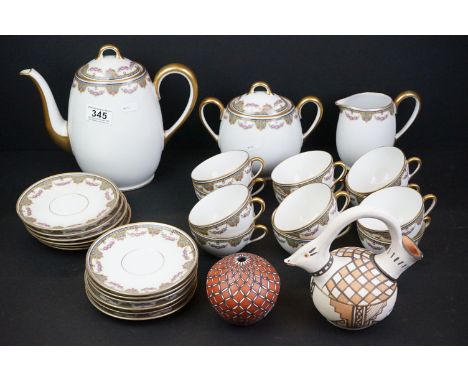 A Limoges coffee set comprising of 12 cups and saucers, lidded sugar bowl, coffee pot and milk / cream jug together with two 