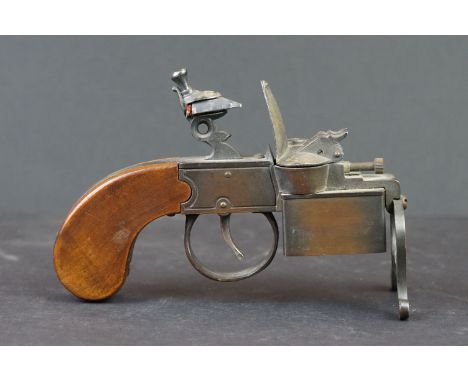 A table lighter in the form of a flintlock pistol, marked Dunhill Tinder Pistol to base. 