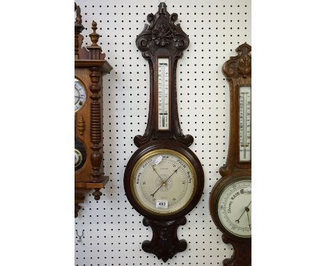 An oak wall hanging barometer with mercury thermometer, marked G.C. Bateman of Brighton. 