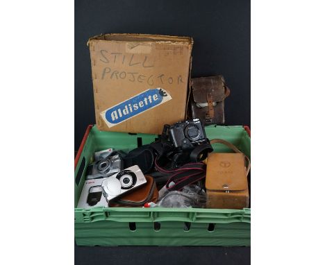 A collection of mixed cameras together with a slide projector. 