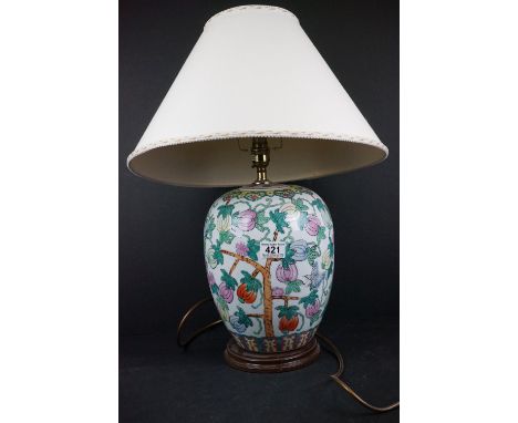 An oriental ceramic table lamp with decorative floral pattern. 