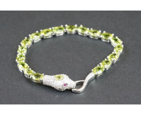 Silver and peridot line bracelet with snake clasp head, set with CZs &amp; ruby eyes 