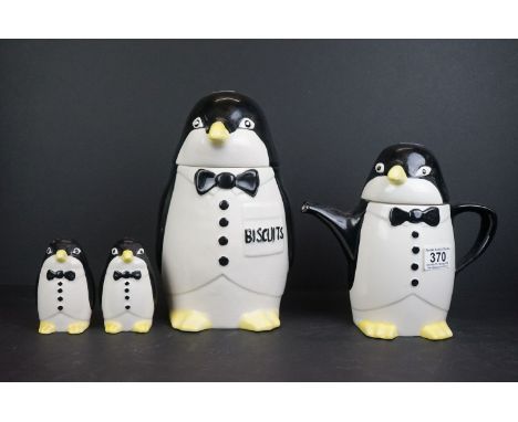 An Art Deco style ceramic teapot in the form of a penguin together with matching biscuit barrel and salt &amp; sugar shakers.