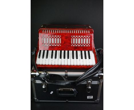 A contemporary Gear For Music Accordion in marbled red with carry case. 