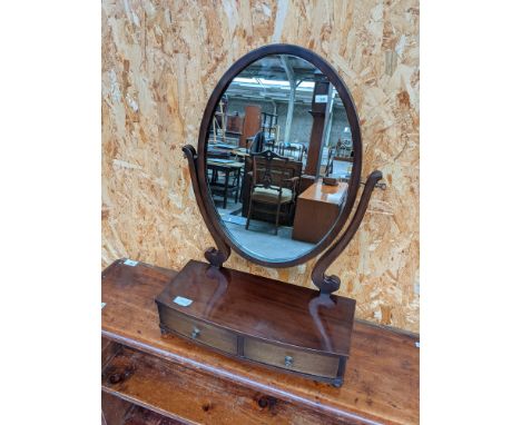 An elegant Victorian oval dressing table mirror, upon a two drawer platform base [height, 59cm, length, 42cm, width, 80cm] 