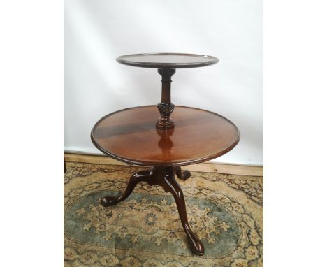 A Georgian dumbwaiter with two dished tiers, supported on baluster columns, on a tripod base with pad feet [small tier diamet