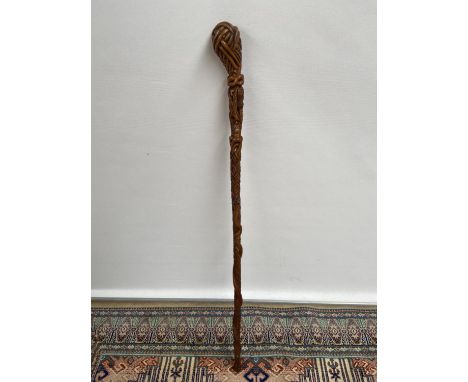 A hand carved walking stick, unusually carved with bats, thistles &amp; snake [length,75cm] 