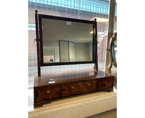 A Georgian mahogany adjustable dressing table mirror upon a three drawer base 