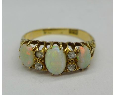 An 18ct gold, opal and diamond ring, 3g, O, hallmark worn