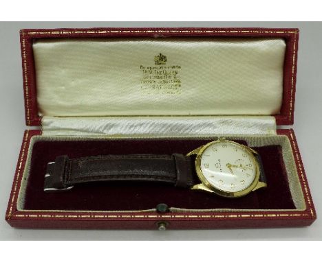 A 9ct gold cased Garrard wristwatch, with box, case back bears inscription, with replacement button