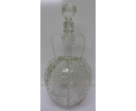 An etched glass decanter, decorated with bunches of grapes, ships and windmills
