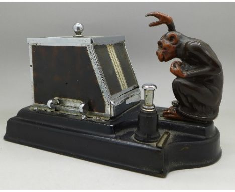 A Ronson Pik-A-Cig novelty table cigarette dispenser and lighter with chimpanzee