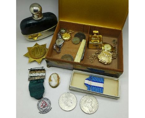 Coins, watches, a cameo brooch, a National Safe Driving Award medal, a pen knife, a hip flask, a Hammarskjold badge and a pla