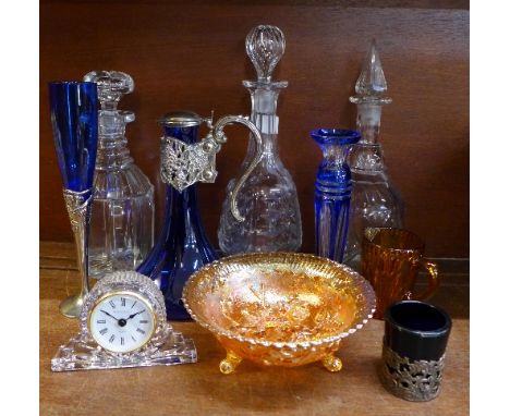 Assorted glass including a blue glass claret jug, a mantel clock, carnival glass and three decanters