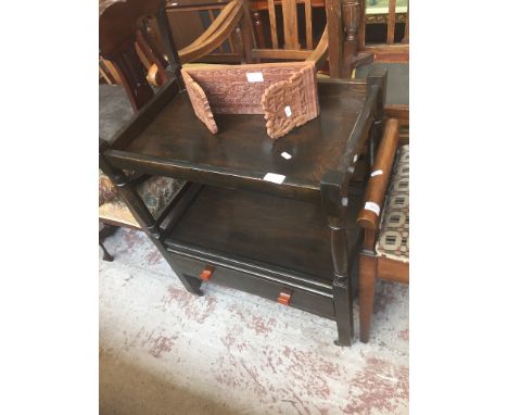 AN OAK TROLLEY WITH LOWER DRAWERS AND SMALL CARVED ITEM