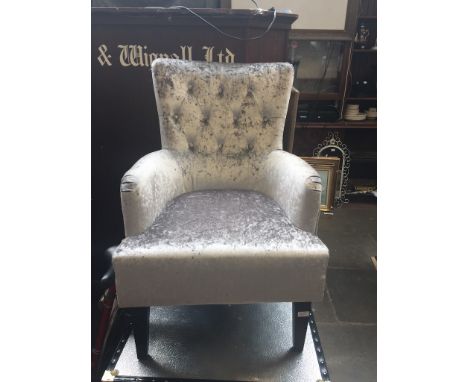 A MODERN BUTTON BACK ARMCHAIR