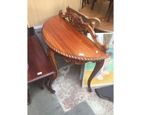 A WALL SHELF AND A CARVED DEMI LUNE TABLE