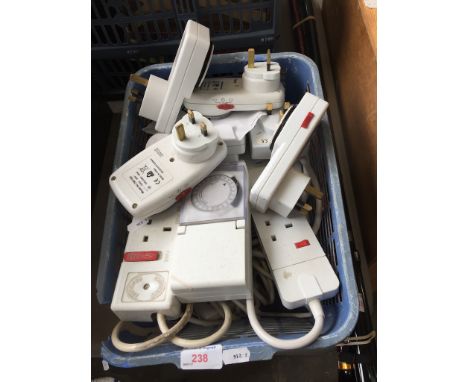 A CRATE OF TIMER PLUGS AND EXTENSIONS