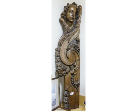   A large 18th century carved oak architectural fragment depciting an angel, fruit and flowers, length 128cm