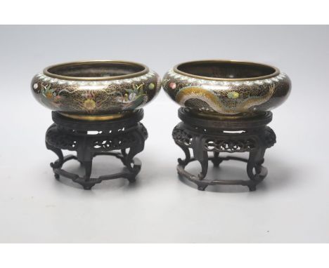   A pair of Chinese cloisonne enamel small 'dragon' bowls, wood stands