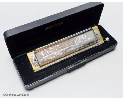   An M.Hohner Super Chromatica 270 deluxe Harmonica, cased