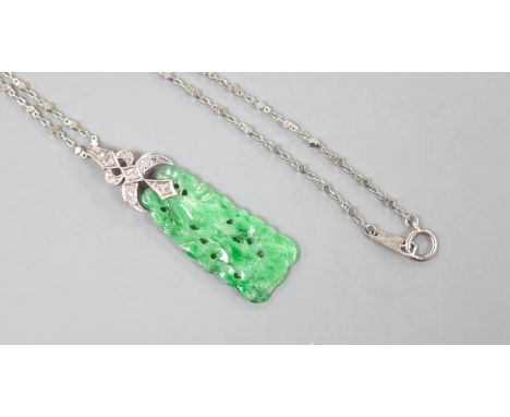   A 1920's white metal and diamond mounted carved jade pendant, numbered 'G 320 1', 4cm, on a platinum fancy link chain, 40cm