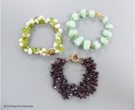   A modern shaped facetted garnet bead twin strand bracelet, with 375 clasp, approx. 19cm, gross 49.2 grams, a similar perido
