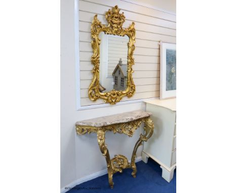   A 19th century rococo revival giltwood console table, 95cm wide, 86.5cm high and a similar later giltwood mirror, 113cm hig