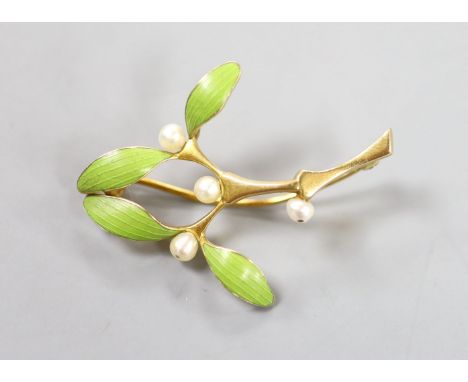   An Art Nouveau yellow metal, green enamel and seed pearl set foliate brooch, 38mm, gross weight 5.2 grams.