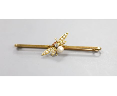   An Edwardian 15ct, diamond and seed pearl set bug bar brooch, with cabochon eyes, 53mm, gross 3.3. grams.