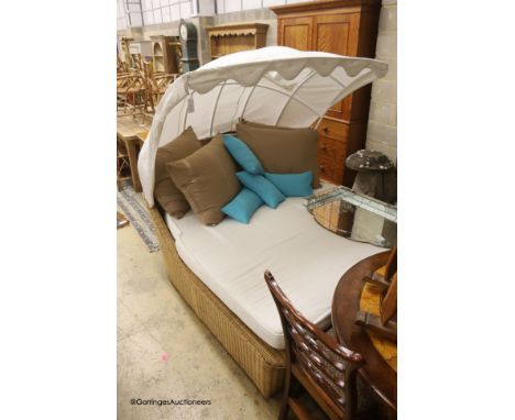   A Bevan Funnel All Weather rattan double garden daybed with metal canopy, mattress and cushions, approx. length 210cm, dept