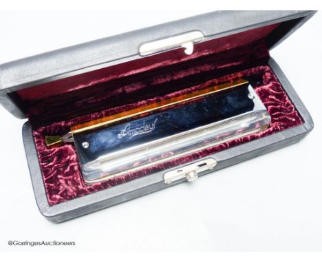   An M.Hohner Amadeus cased harmonica