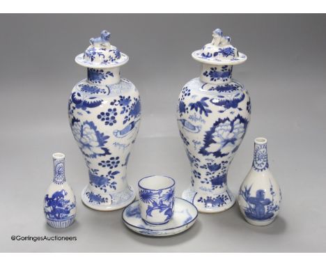   A pair of lidded Chinese blue and white vases, c.1900, Kangxi marks, 23cm high, together with two small Japanese vases, and