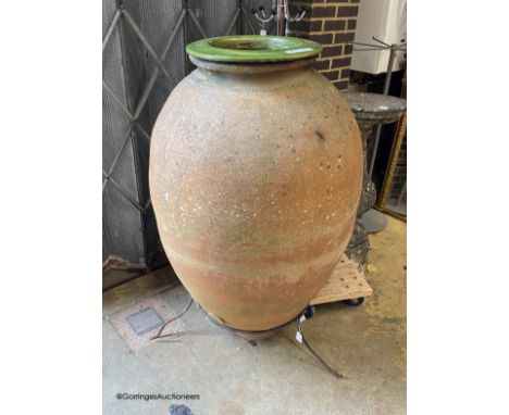   A large antique Italian oil jar, on iron stand with ceramic liner, height 144cm