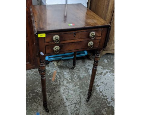 A Regency mahogany two drawer work table with inlaid ebony stringing to drawer fronts, twin fall flaps on ring turned legs an