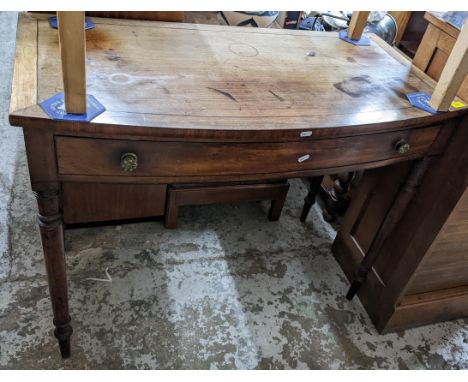 A Regency mahogany bow fronted side table with single drawer on ring turned legs Location:If there is no condition report sho
