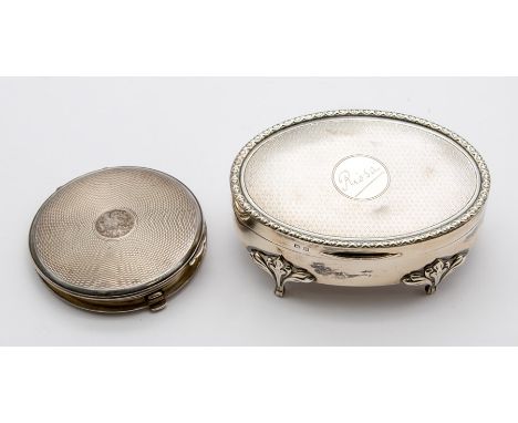 A George V silver oval shaped ring box, engine turned cover with geometric raised border, plain body on four scroll feet, the