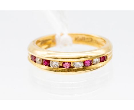 A ruby and diamond  half eternity 18ct gold ring, comprising alternate channel set round cut ruby and diamonds, size O, total