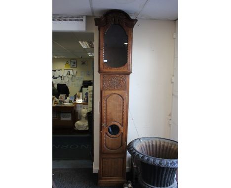 A late 19th / early 20th Century oak longcase clock, hand carved case, the white dial inscribed Lateuitie, with black Roman n