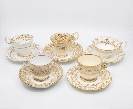 A collection of early to mid 19th Century tea cups and saucers, mainly gold patterns from Staffordshire factories, mostly unn
