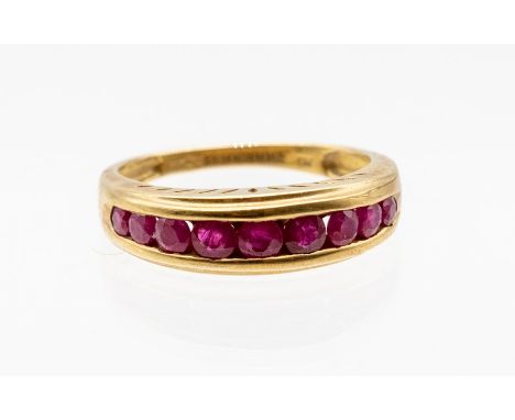 A ruby and 9ct gold ring, comprising nine graduated round cut rubies, weighing approx 0.91cts, channel set, rubies of Burmese